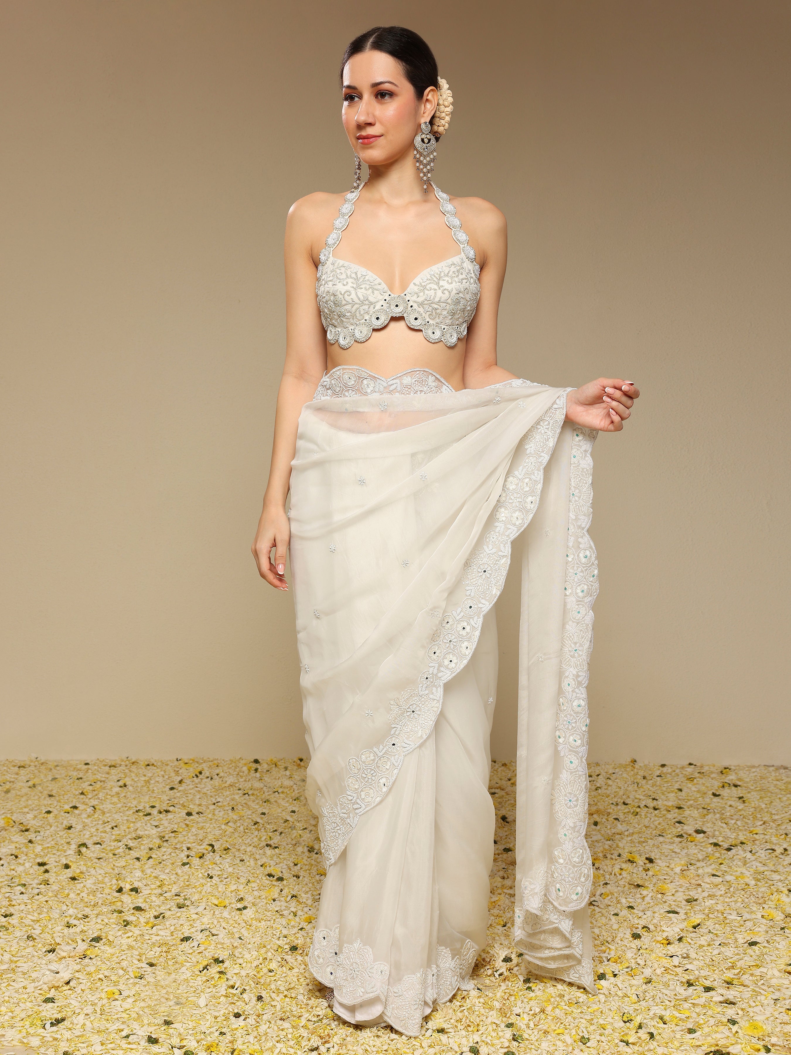 Woman wearing a coordinated blouse paired with ivory zardozi embroidered saree