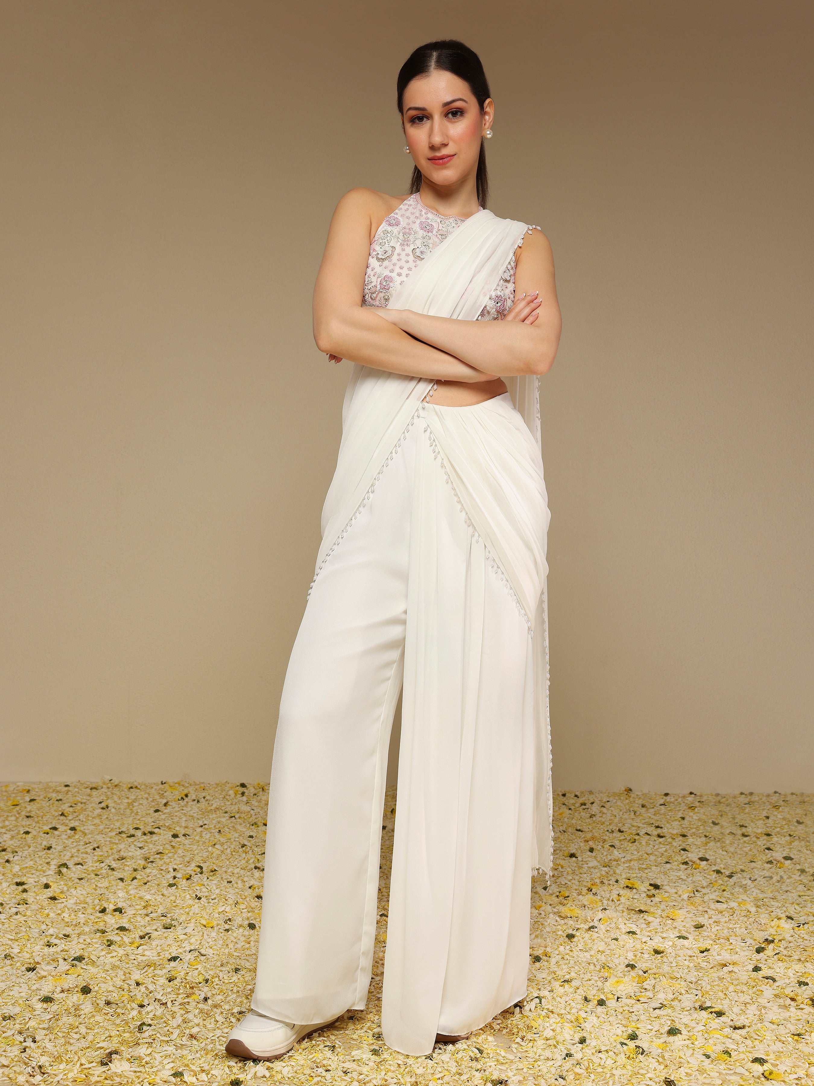 Front view of woman wearing an ivory predraped pant saree set