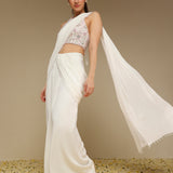 Woman wearing an ivory pre draped saree with embroidered organza blouse