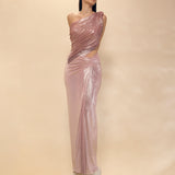 Woman wearing a one-shoulder evening gown with cut-out design on a beige background