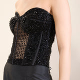 Close-up of intricate bead and sequin work on corset