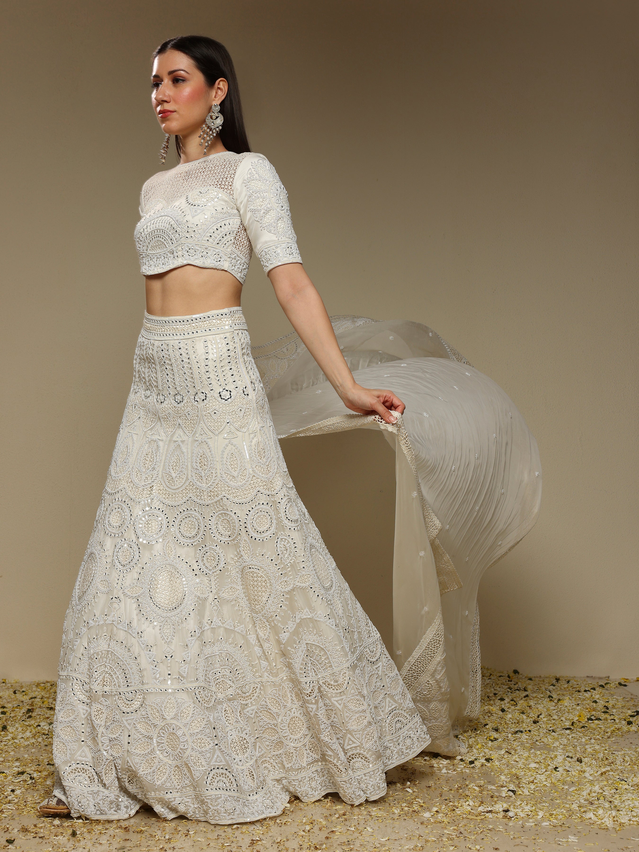 Full ivory lehenga outfit showcasing pearl and threadwork embellishments