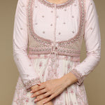 White traditional outfit with intricate embroidery on a beige background
