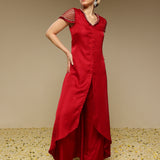 Woman wearing a red kurta set with a plain background