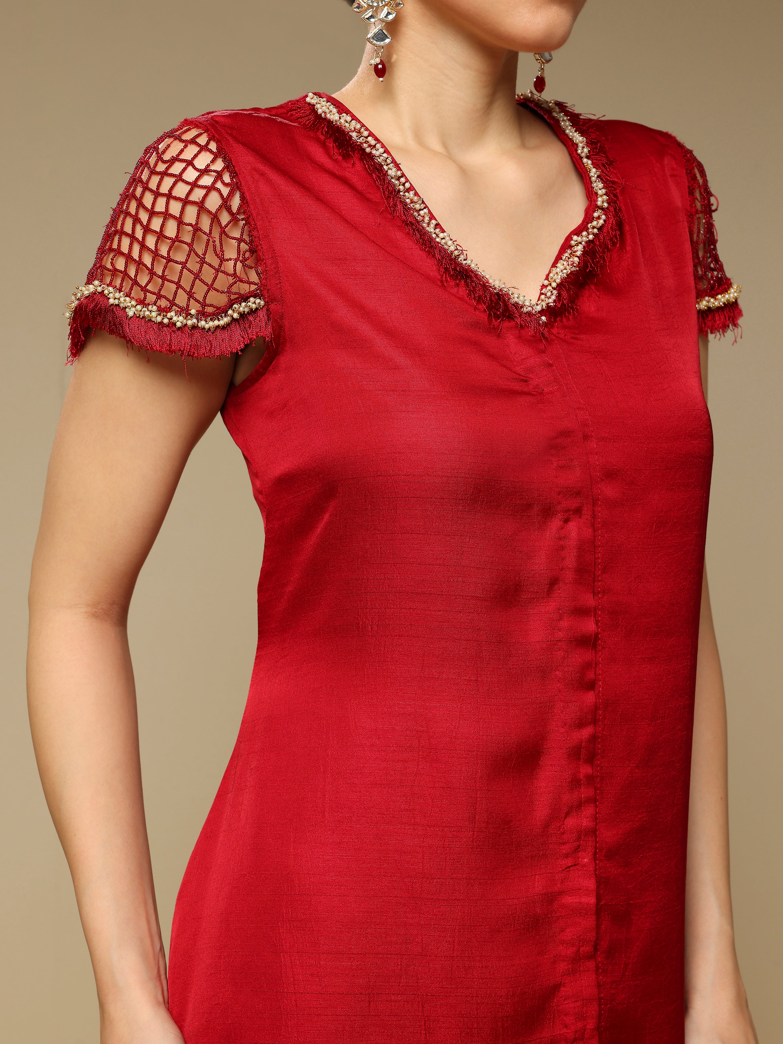 Red dress with lace details on a beige background