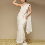 Woman in an ivory scalloped saree with intricate zardozi embroidery
