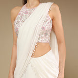 Close-up of zardozi embroidery on blouse and pearl drop detailing on ivory saree pallu