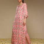 Woman wearing a pink floral dress with a beige background