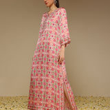 Woman wearing a pink floral dress with a beige background