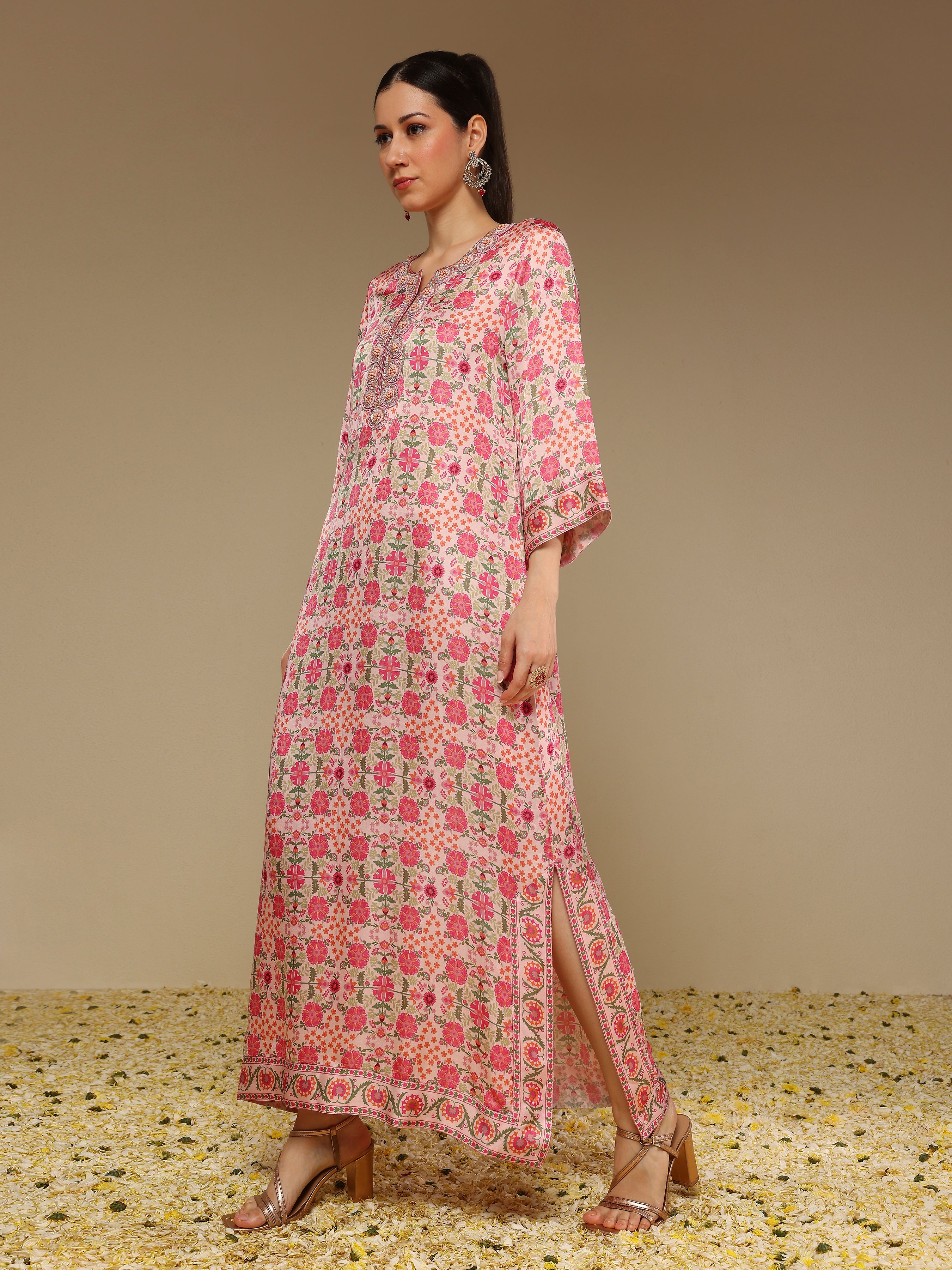 Woman wearing a pink floral dress with a beige background