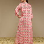 Woman wearing a pink floral dress with a beige background