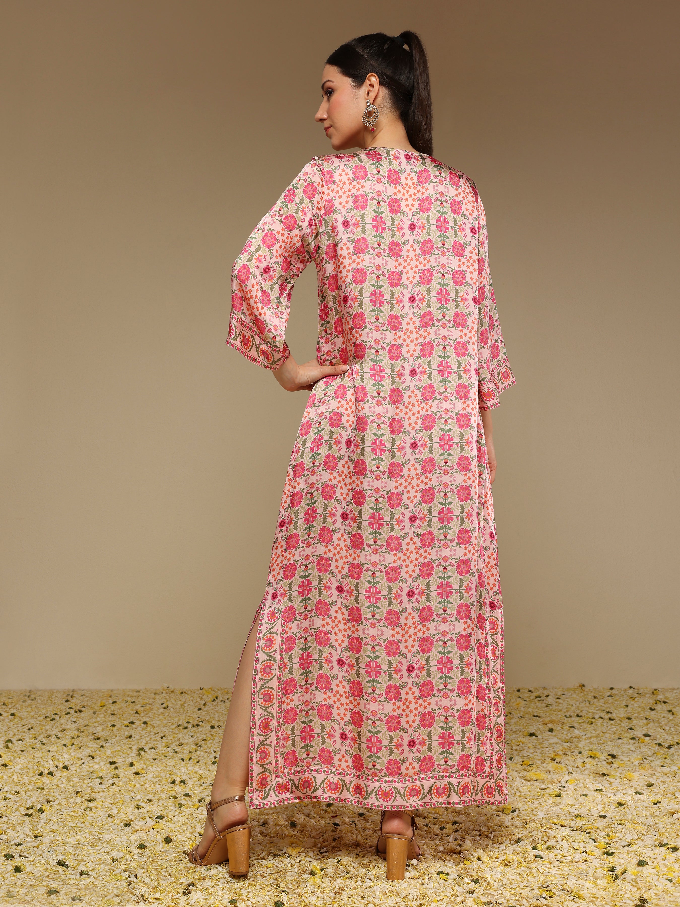 Woman wearing a pink floral dress with a beige background
