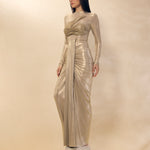 Woman wearing a metallic silver evening gown against a neutral background