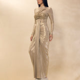 Woman wearing a metallic silver evening gown against a neutral background
