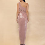 Woman wearing a one-shoulder pink dress on a beige background
