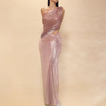 Woman wearing a one-shoulder evening gown with cut-out design on a beige background