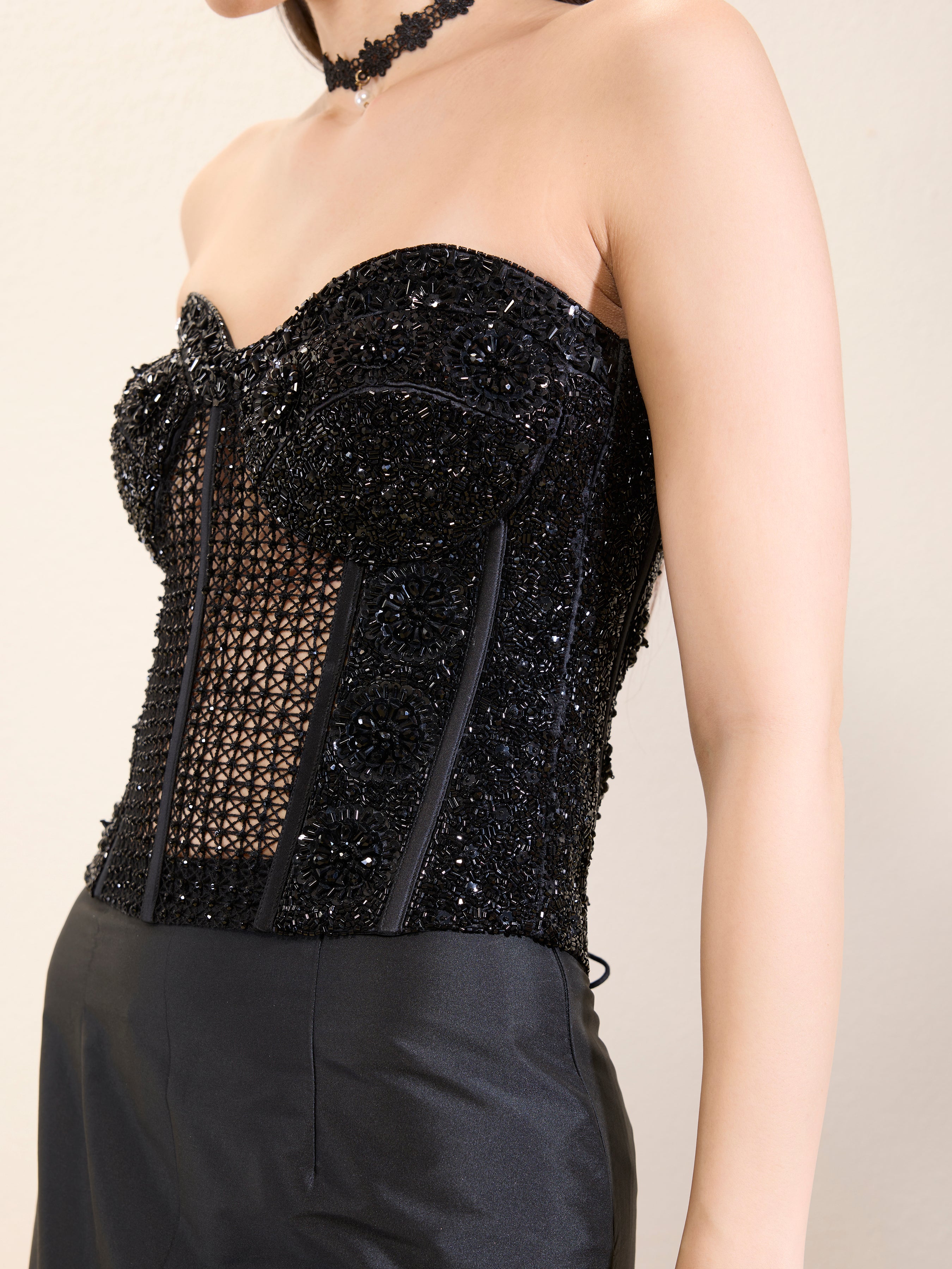 Close-up of intricate bead and sequin work on corset