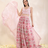 Woman wearing a printed georgette lehenga and dupatta with embroidered spun silk blouse