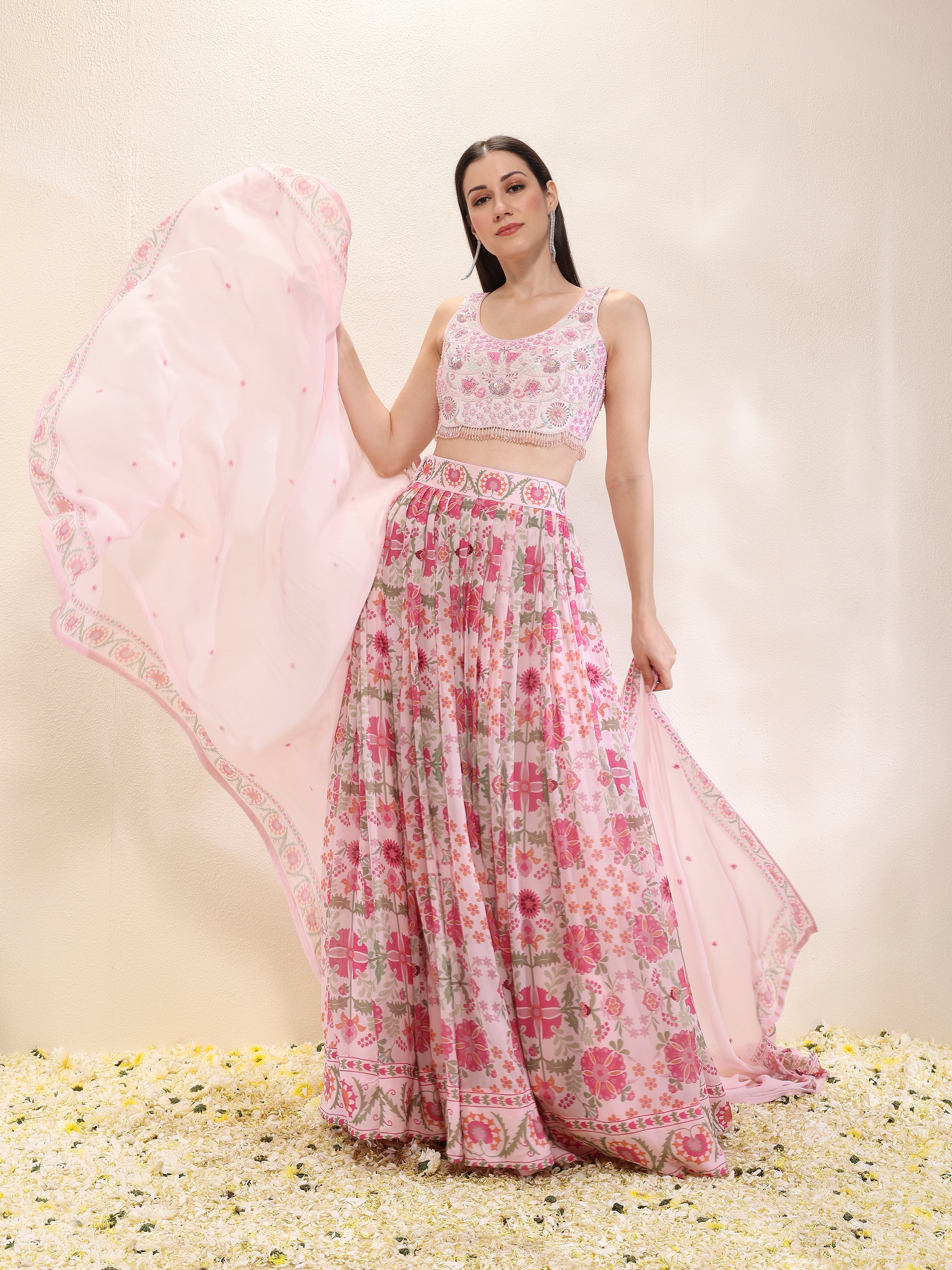 Woman wearing a printed georgette lehenga and dupatta with embroidered spun silk blouse