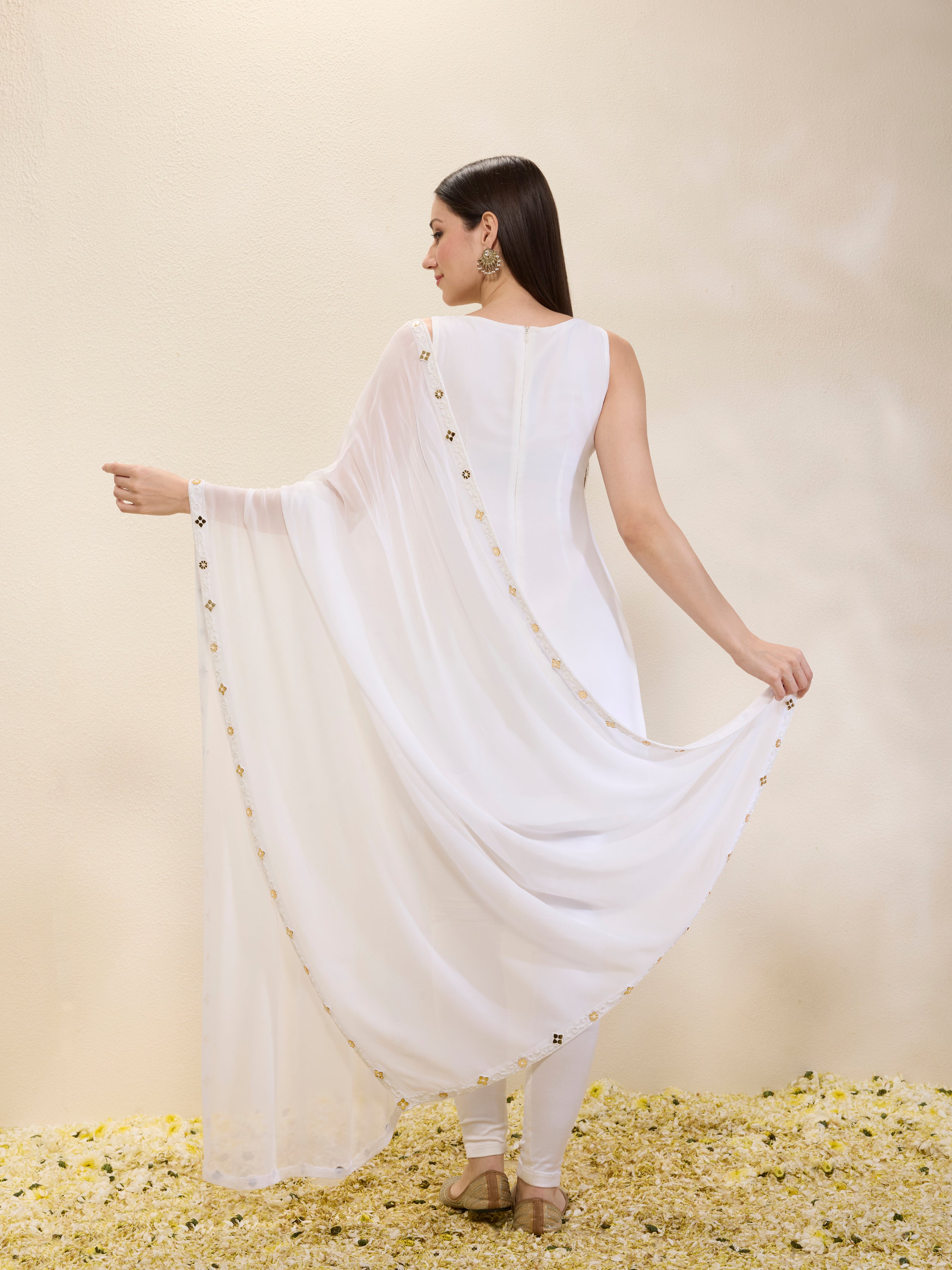 Woman wearing a white dress with a plain background