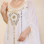 White dress with gold embroidery on a beige background
