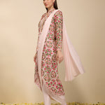 Side view of woman wearing a multi-colored pre draped saree with embroidered jacket