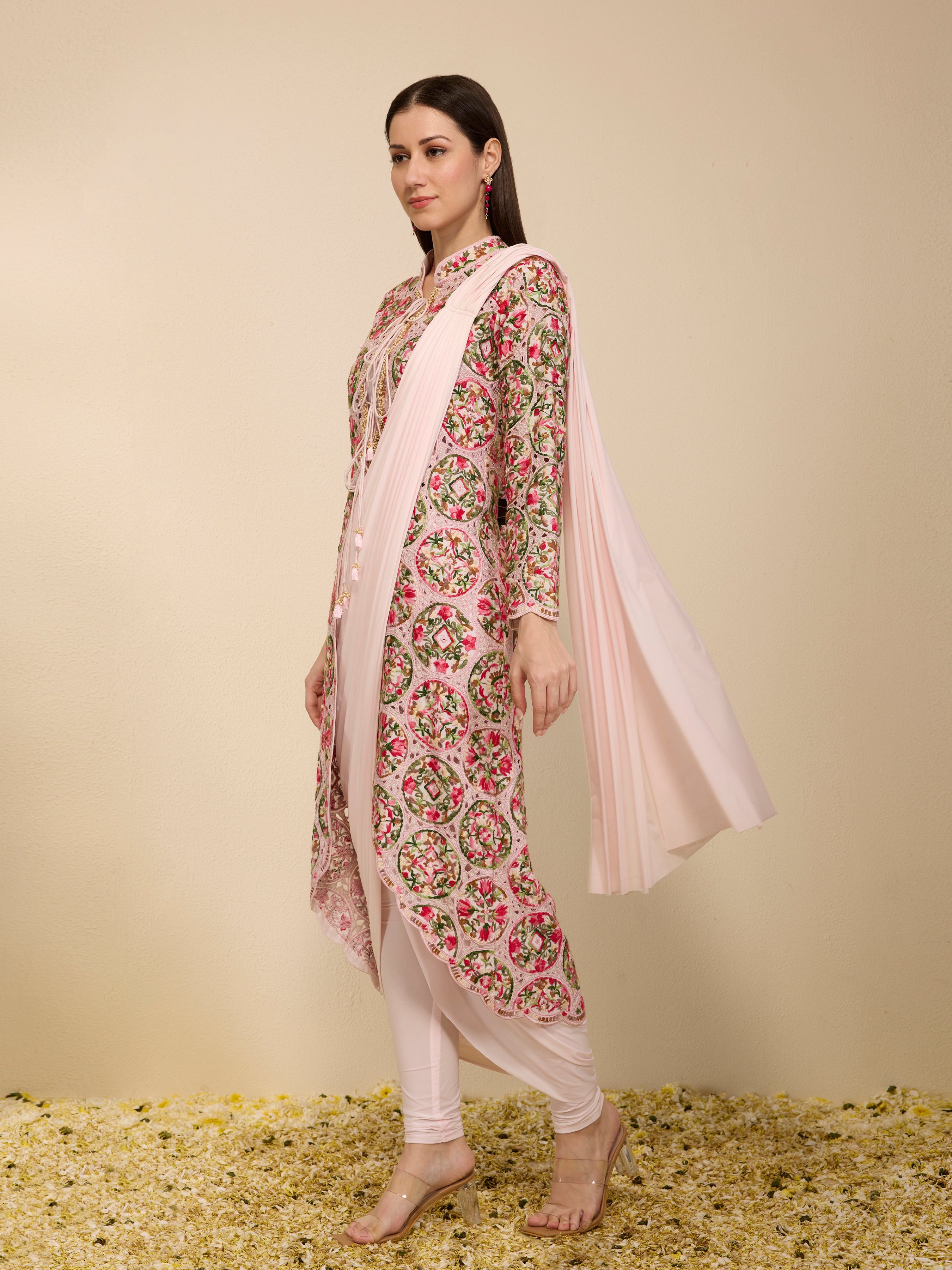 Side view of woman wearing a multi-colored pre draped saree with embroidered jacket