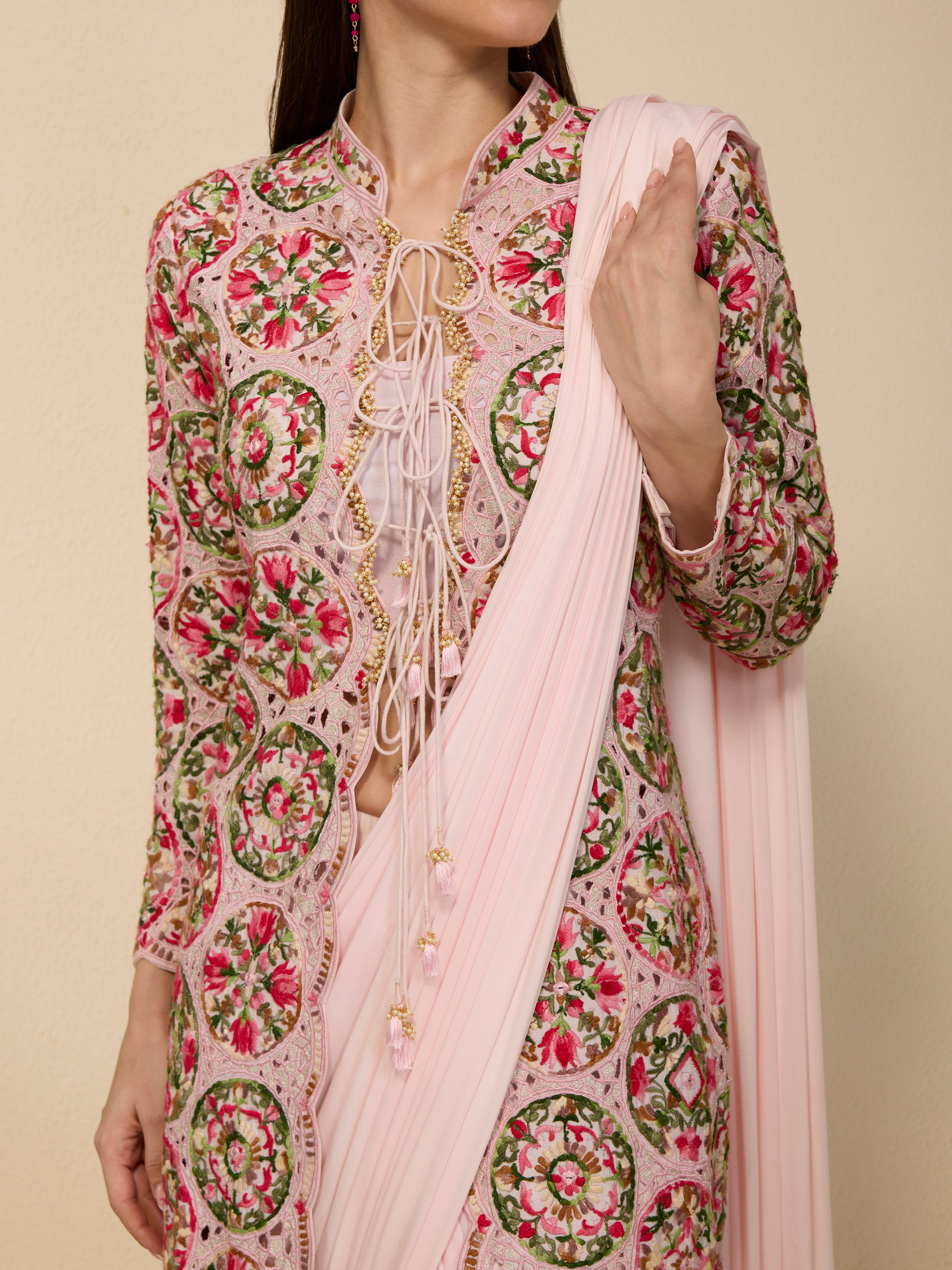 Close-up of thread and cutwork embroidery on multi-colored spun silk jacket