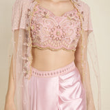 Pink embroidered blouse with matching skirt on a plain background