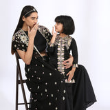 Jet black jumsuit with an embroidered open jacket paired with Black Embroidered Kurta teamed with matching narrow pants